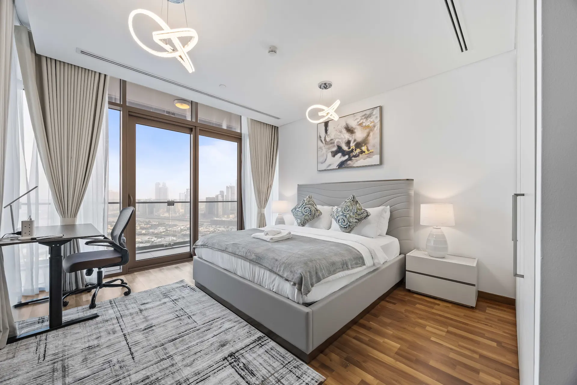 Bedroom with workspace and panoramic views at Burj Daman DIFC Dubai