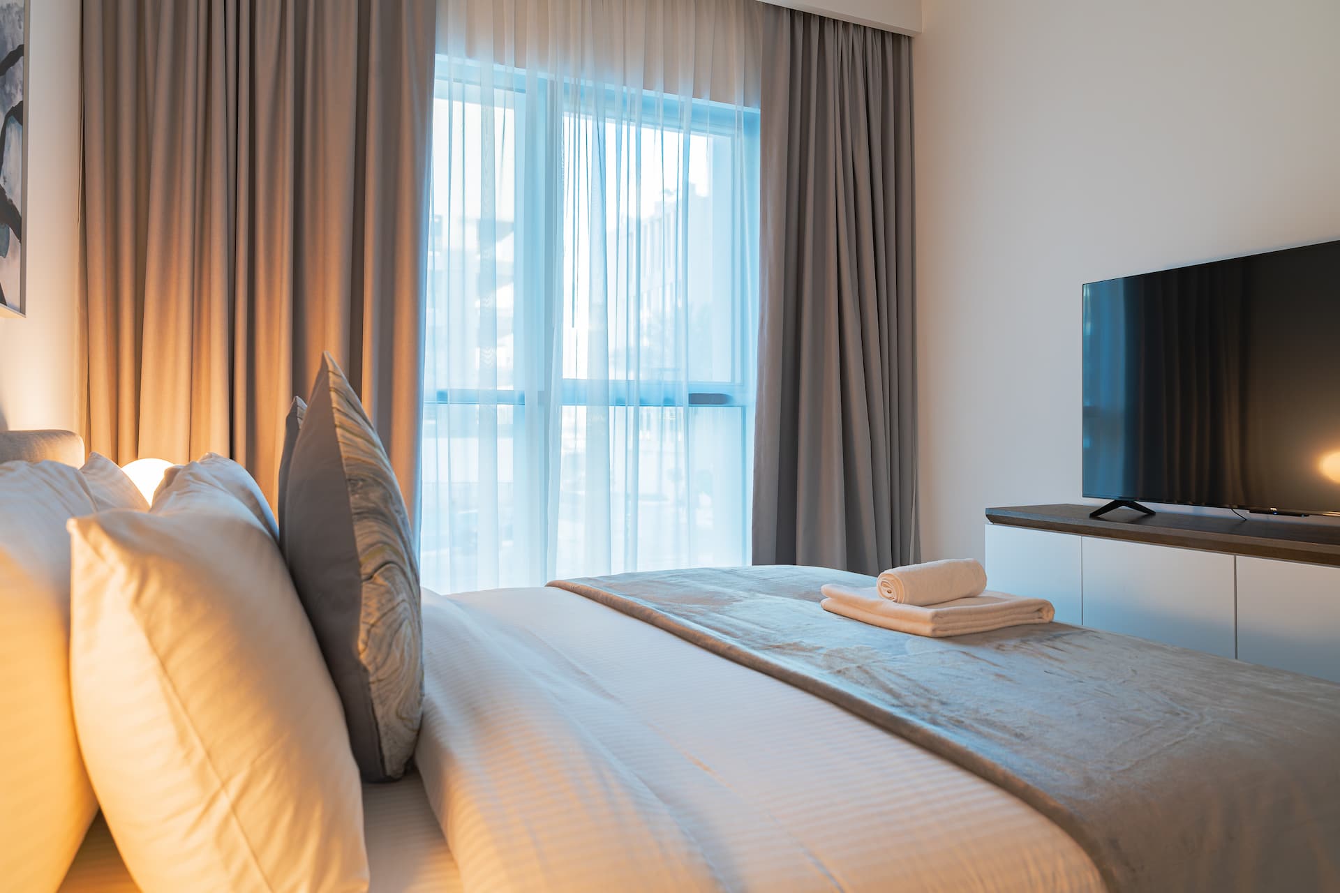 Bedroom detail with premium linens and Smart TV in contemporary one bedroom apartment Beach Isle Tower Two Emaar Beachfront