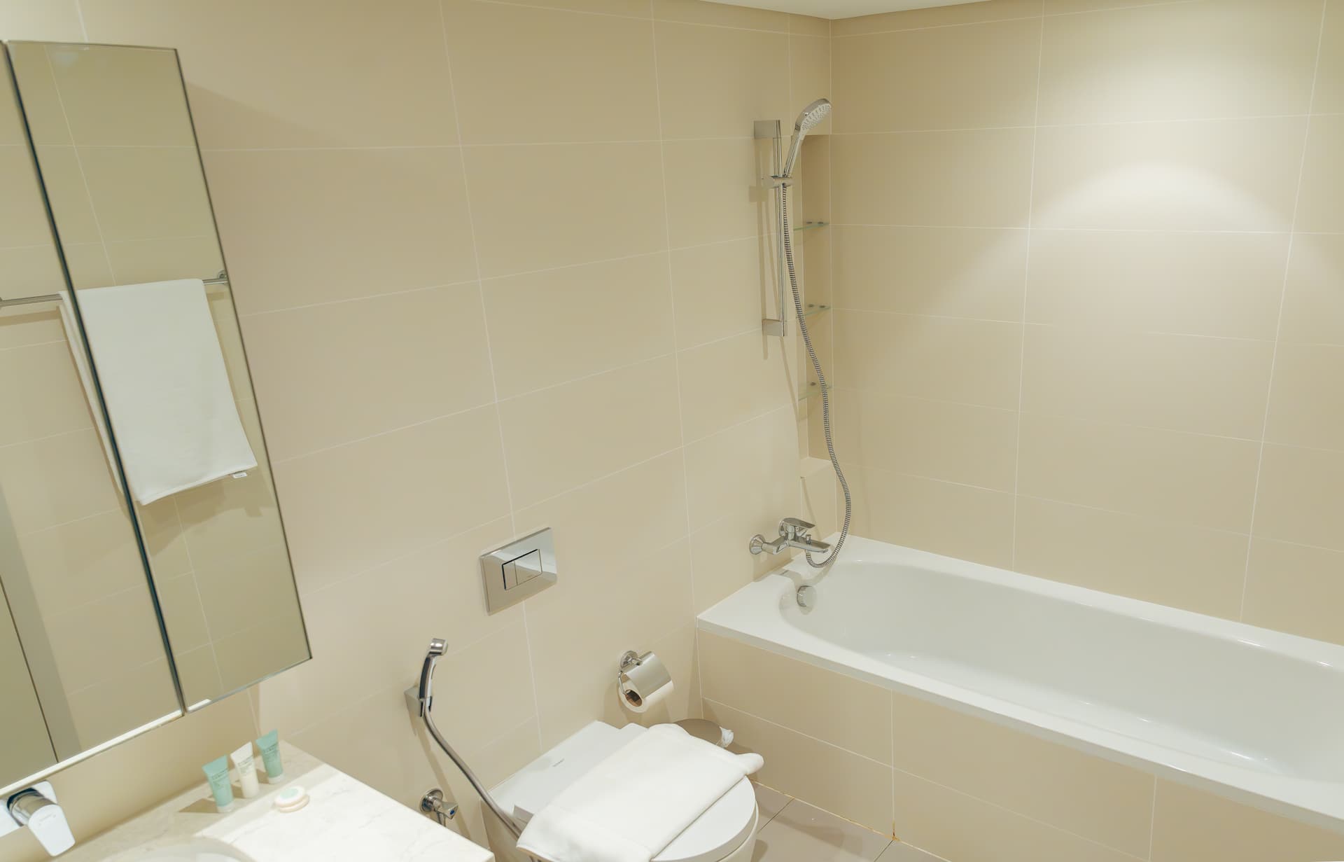 Ensuite bathroom with bathtub and premium toiletries in luxury one bedroom apartment Emaar Beachfront Dubai