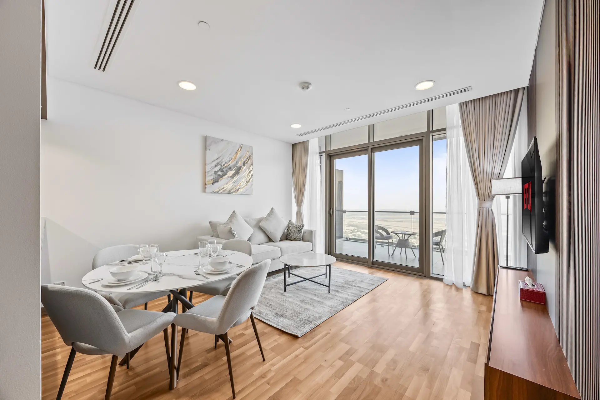 Open plan living area with balcony access at Burj Daman DIFC Dubai