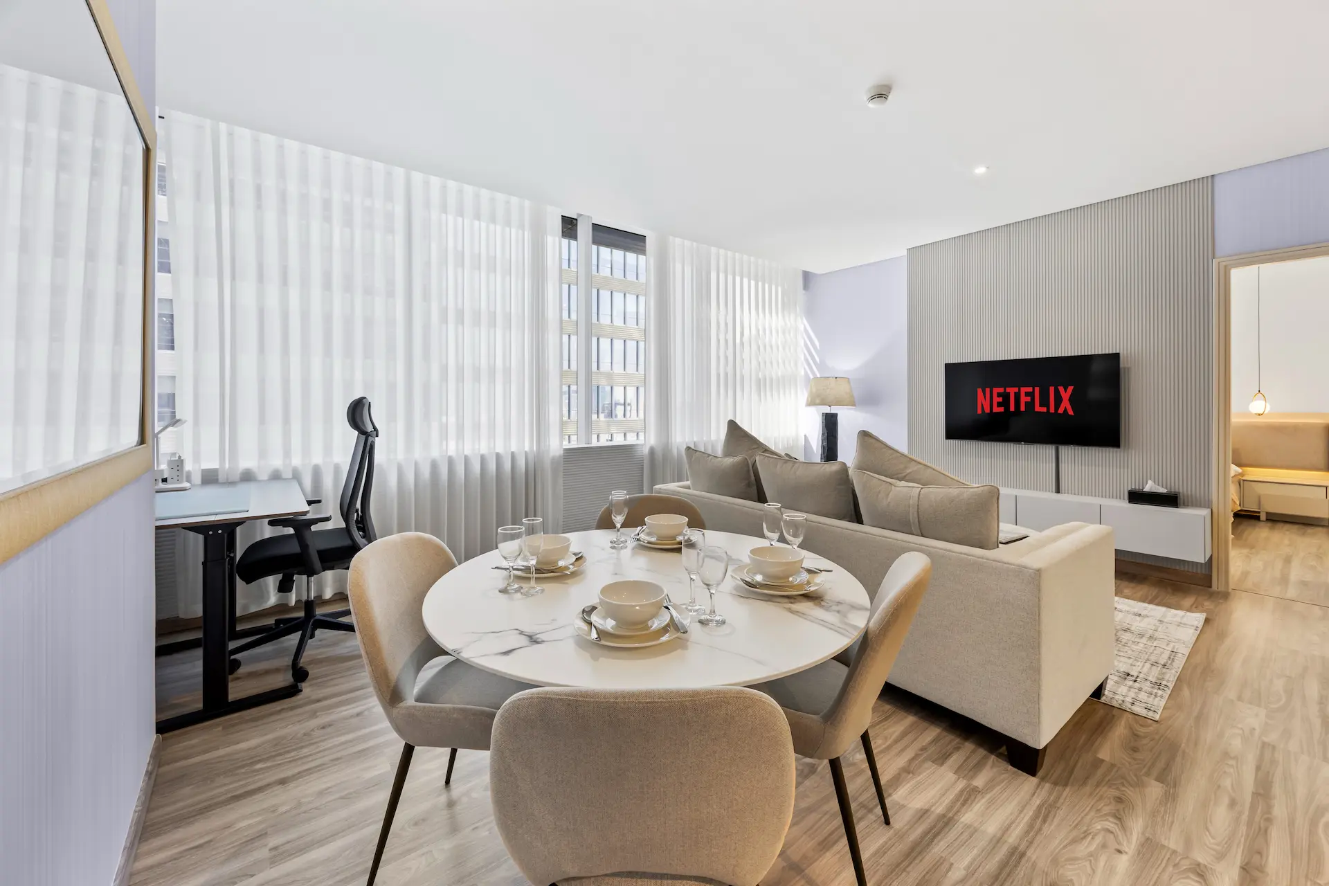 Dining and living area with workspace in premium one bedroom apartment Sky Gardens DIFC