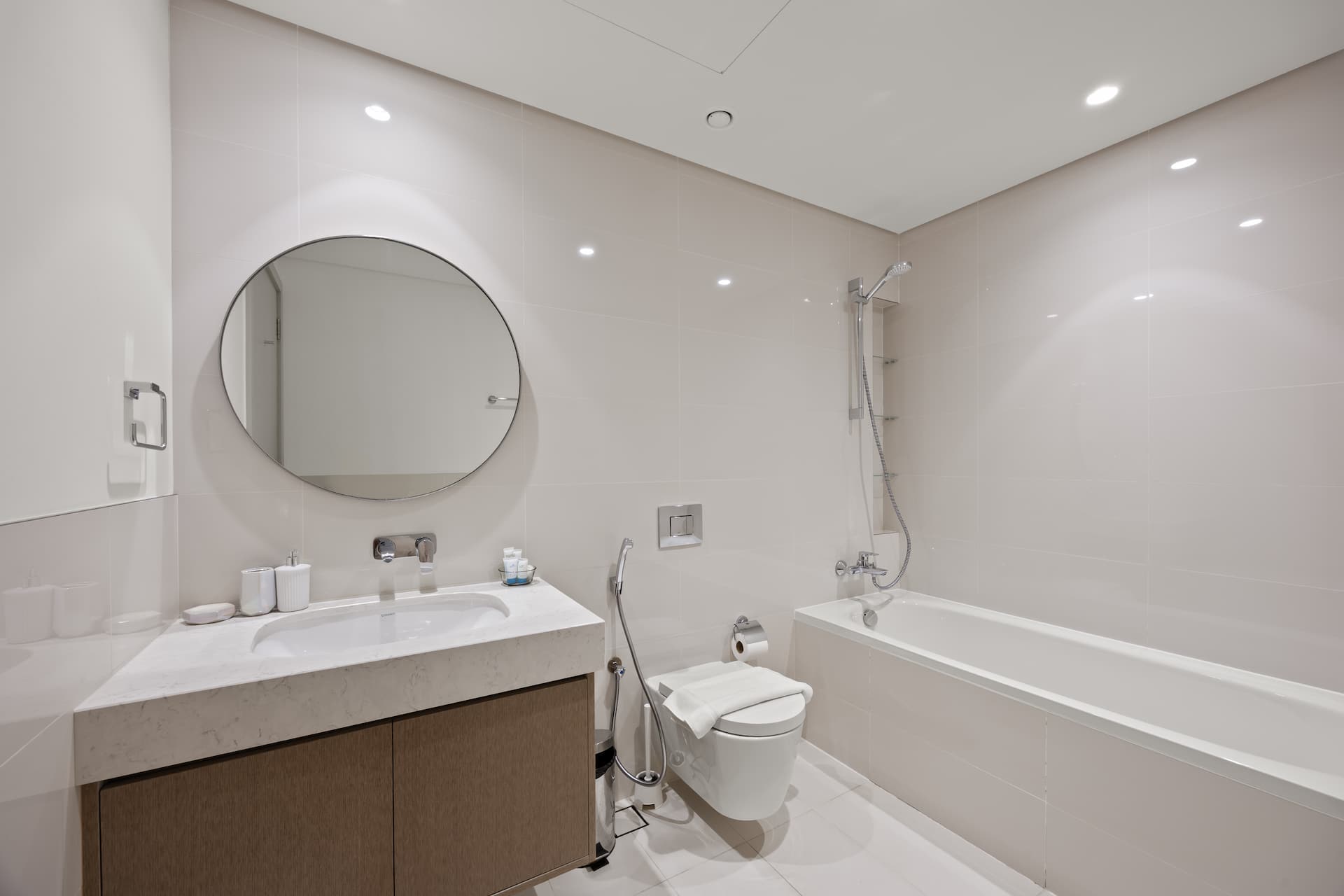Guest bathroom with marble vanity and soaking bathtub in two bedroom serviced apartment Emaar Beachfront Dubai