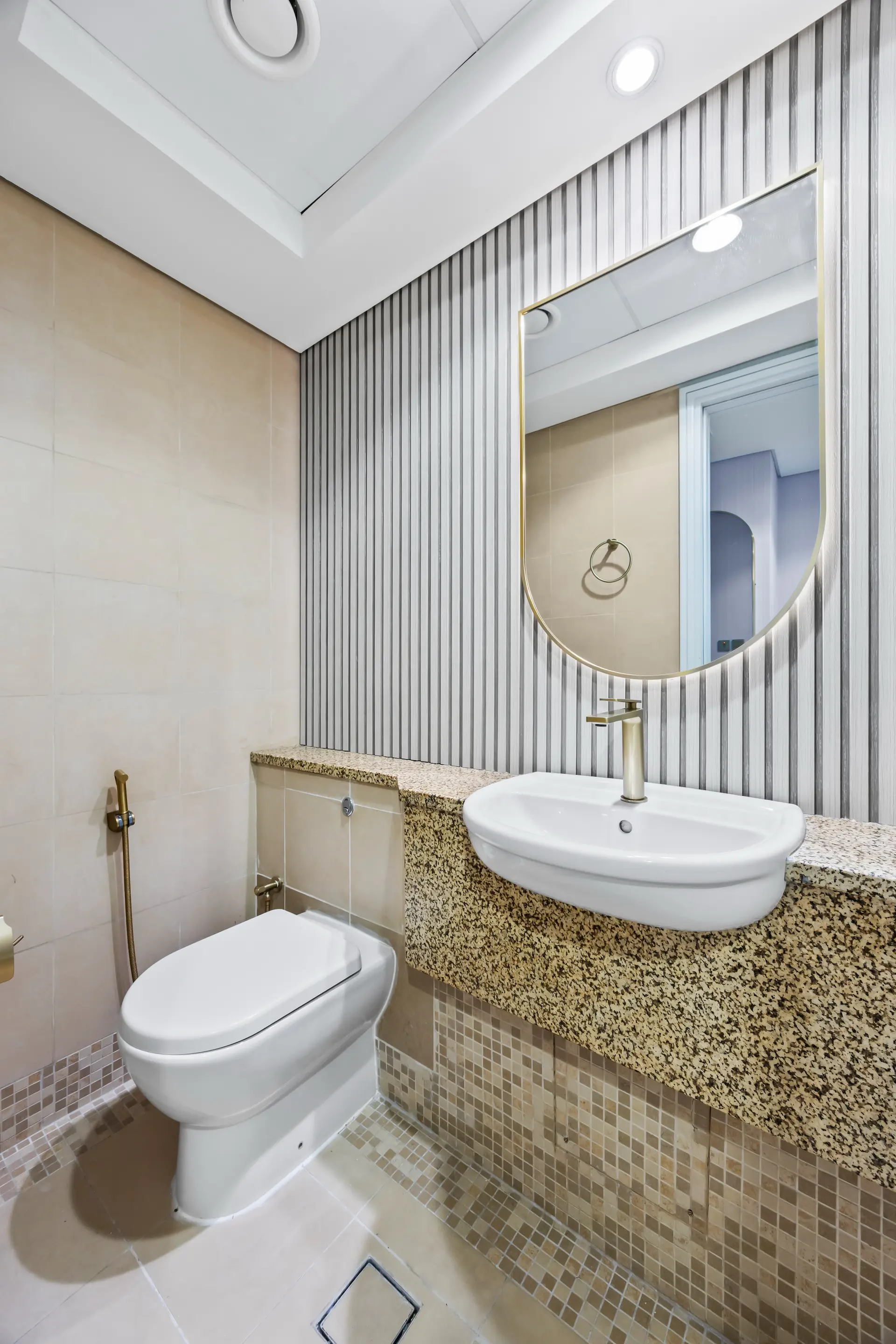 Modern bathroom with gold fixtures in premium one bedroom apartment Sky Gardens DIFC Dubai