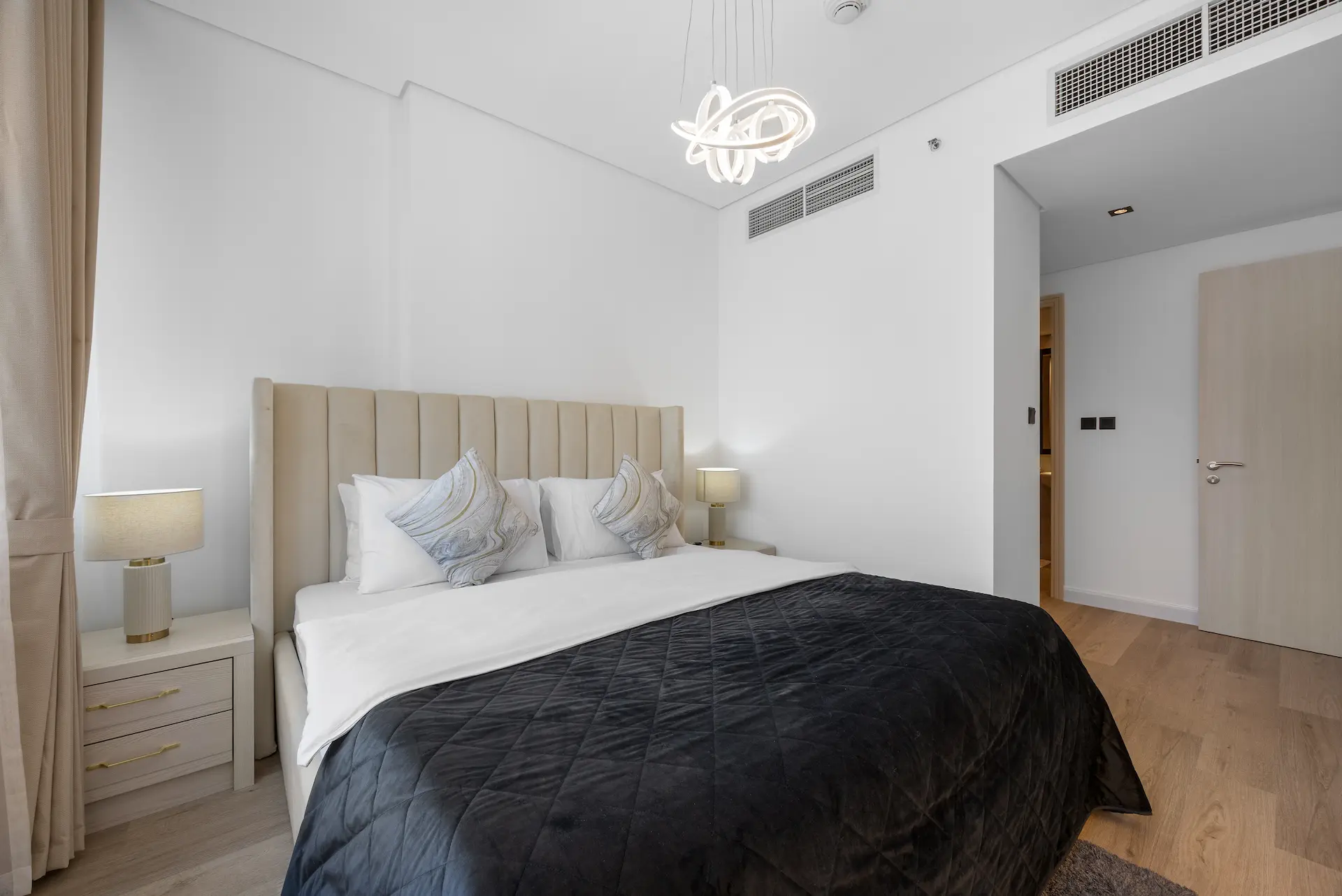 King bedroom with premium bedding and designer pendant light at Sky Gardens DIFC Dubai