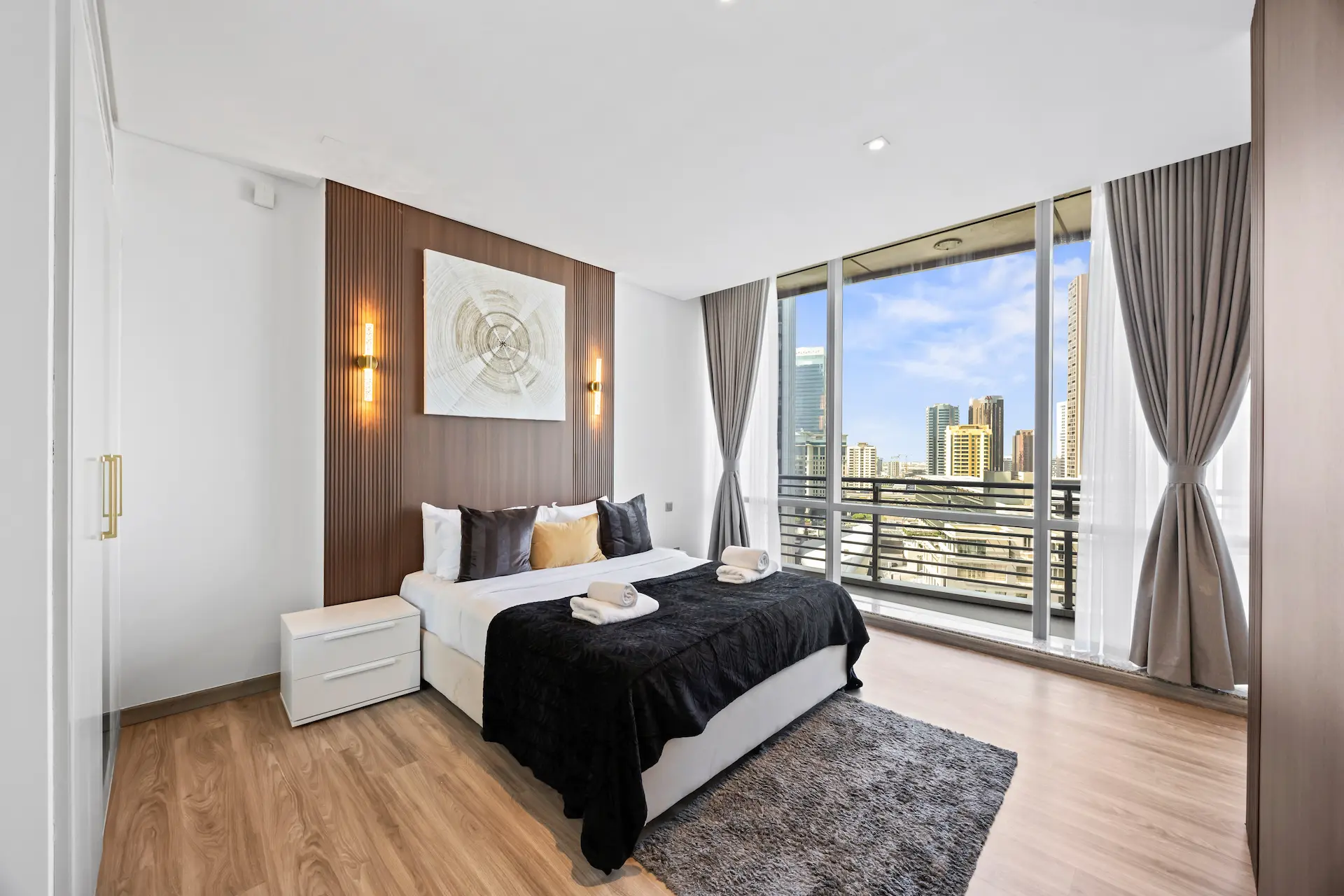 King bedroom with city views and floor-to-ceiling windows in executive studio Sky Gardens DIFC Dubai
