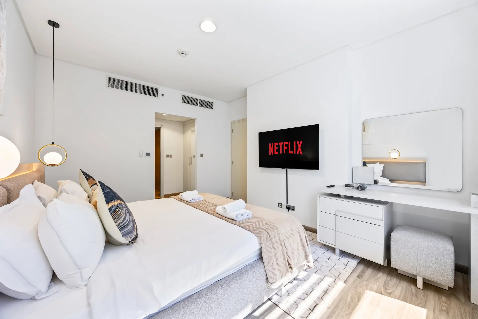 Bedroom with Netflix smart TV and workspace in Sky Gardens DIFC apartment