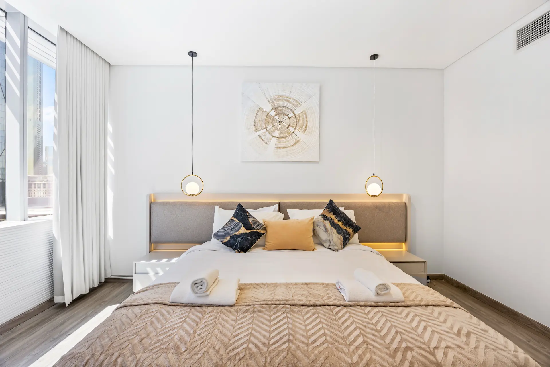 Master bedroom with designer pendant lights in premium one bedroom apartment Sky Gardens DIFC Dubai
