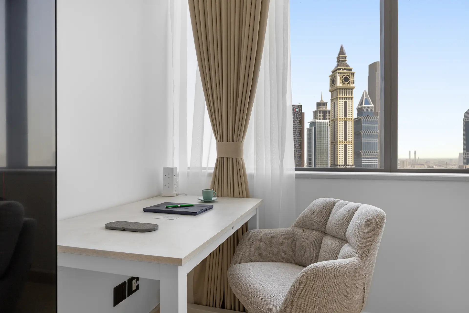 Dedicated workspace desk with Emirates Towers golden-hour view at Sky Gardens DIFC Dubai