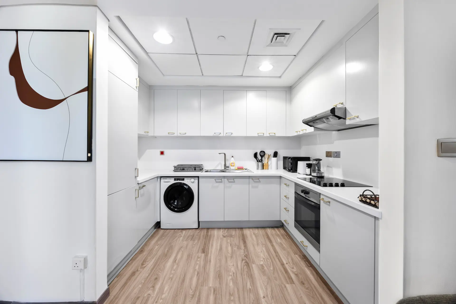 Modern kitchen with washer dryer and full appliances in executive studio Sky Gardens DIFC Dubai