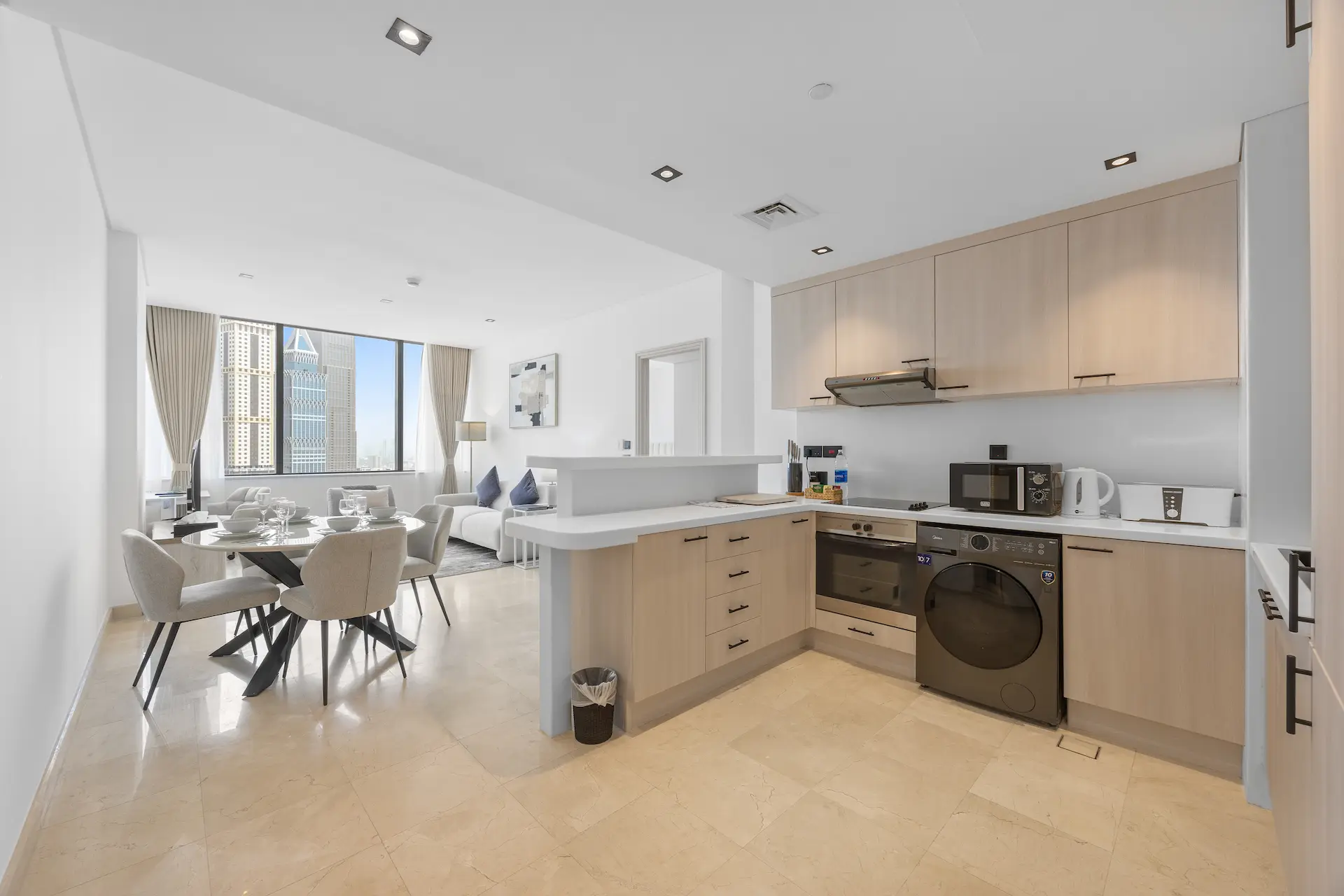 Open-plan kitchen, dining and lounge with DIFC skyline views at Sky Gardens Dubai