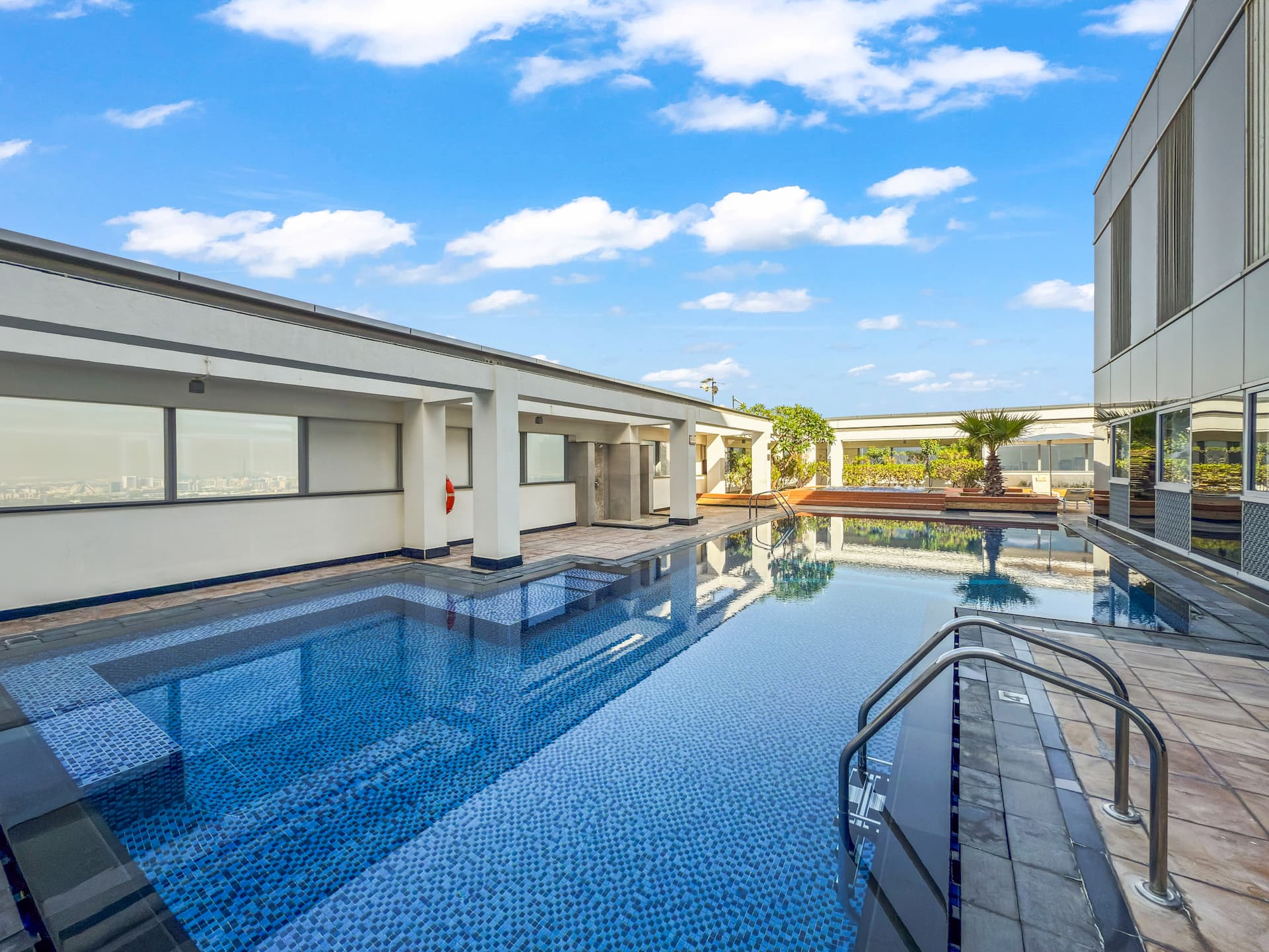 Rooftop pool at Sky Gardens DIFC Dubai with city skyline views